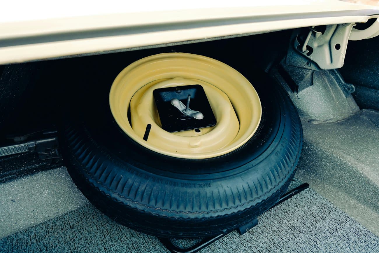 Spare wheel and tire stored in a car trunk